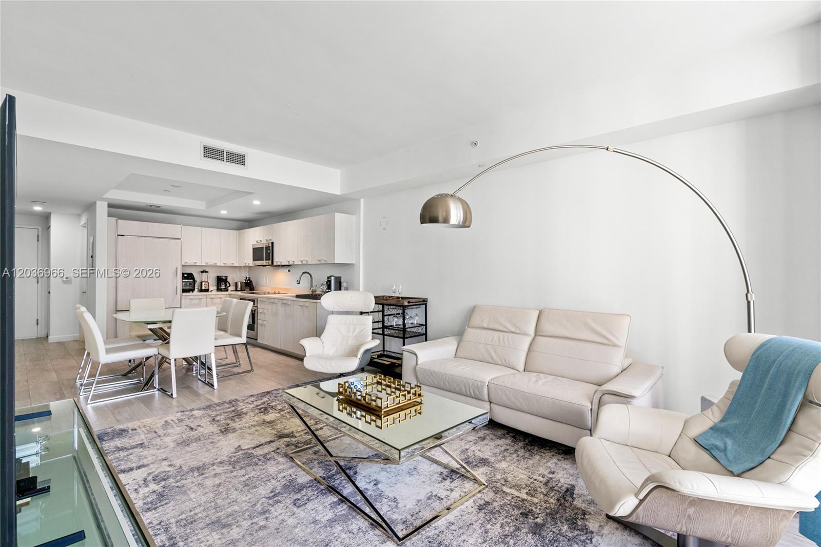 55 Southwest 9th Street, Unit 1904 Miami, FL 33130 - Photo 13 of 66 a living room with furniture rug and wooden floor