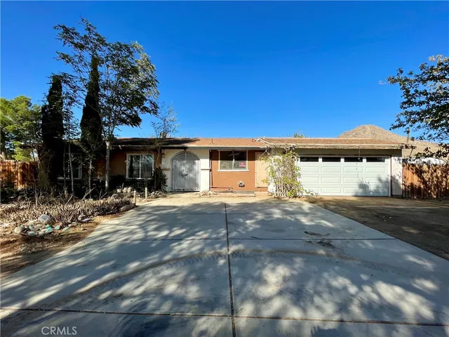 a view of a house with a yard and tree s
