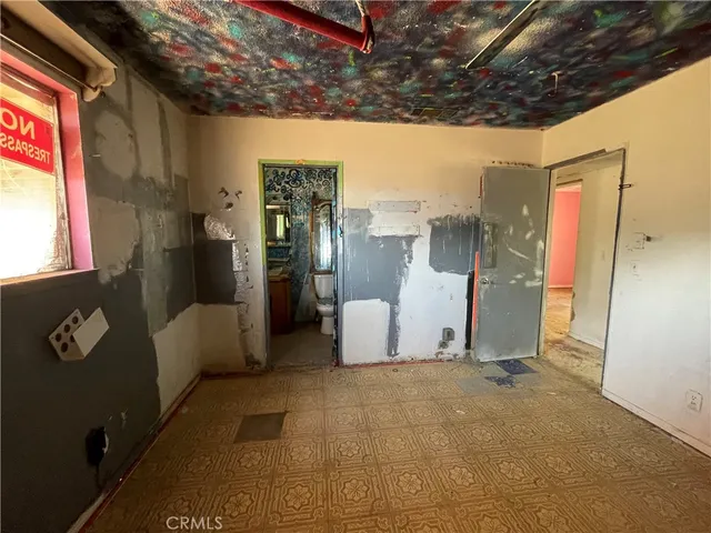 a view of a room with a refrigerator