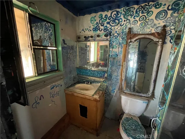a bathroom with a toilet sink and mirror