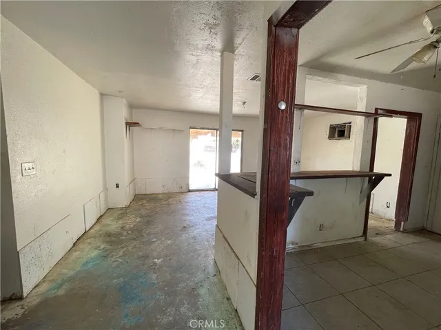 a view of a hallway with wooden floor and a glass door