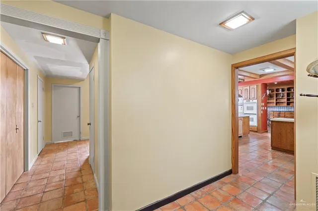 a view of a hallway with wooden shelves