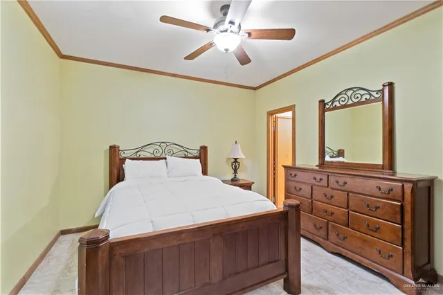 a bedroom with a bed and a mirror on dresser