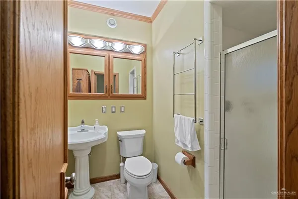 a bathroom with a toilet sink shower and mirror