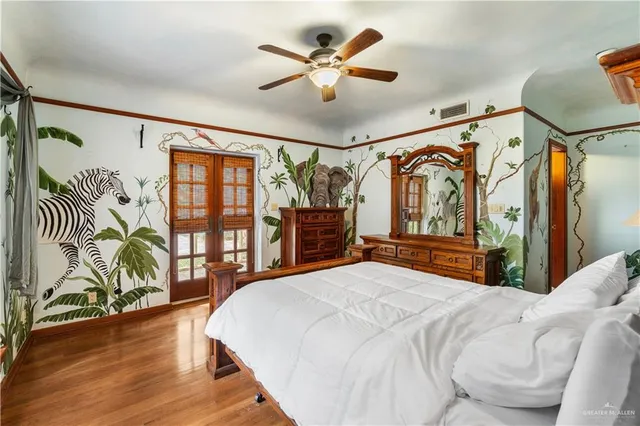 a bedroom with a bed and a chandelier