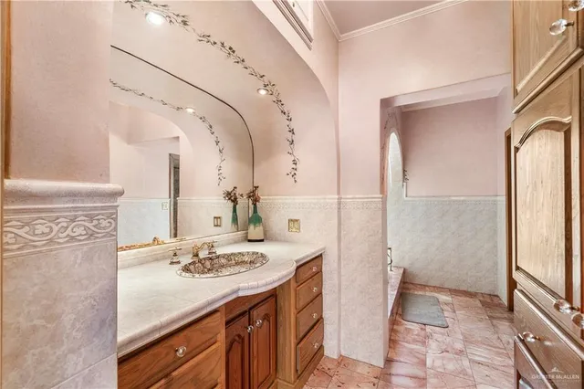a bathroom with a granite countertop sink a mirror and shower