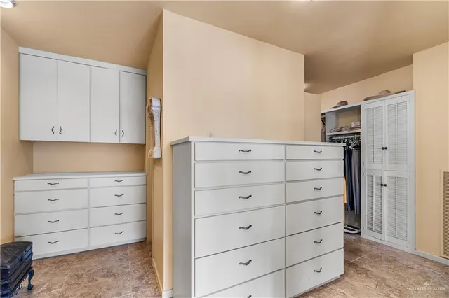 a view of wooden closet cabinets and utility room