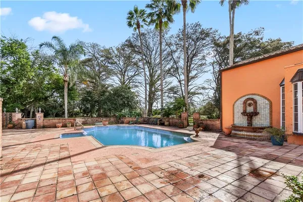 a view of a street with cars parked in front of it