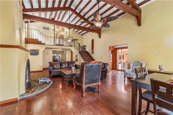 a living room with furniture and a wooden floor