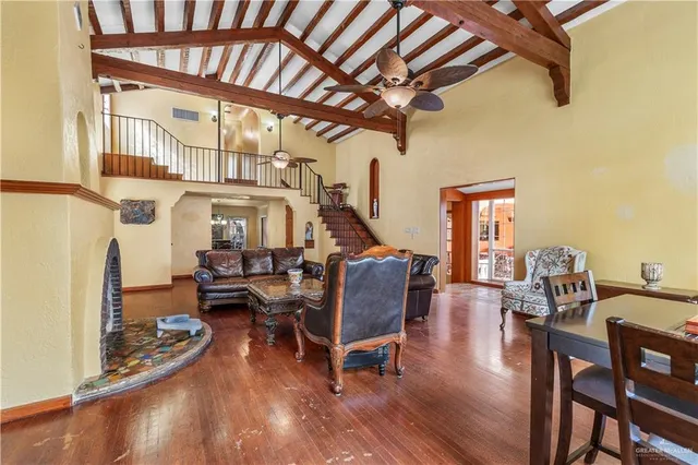a living room with furniture and a wooden floor