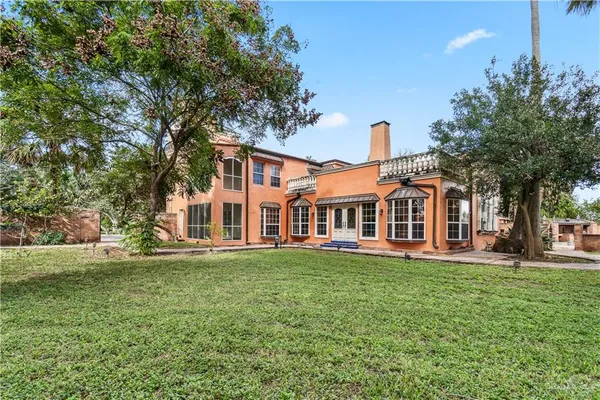 a garden with trees in front of it