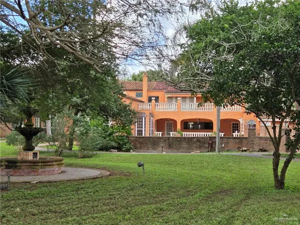 a swimming pool is sitting in the grass near a tree