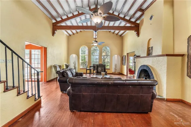 a living room with fireplace furniture and a large window