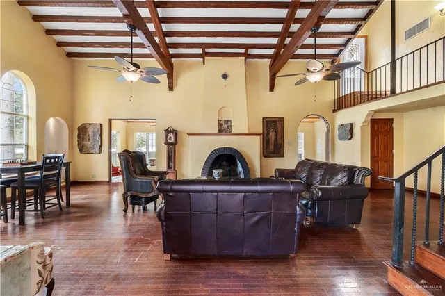 a living room with furniture a fireplace and wooden floor