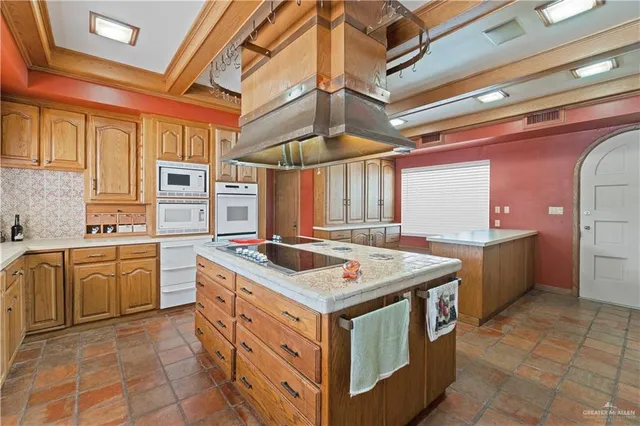 a kitchen with a stove and a refrigerator