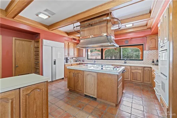 a kitchen with stainless steel appliances granite countertop a stove and a refrigerator