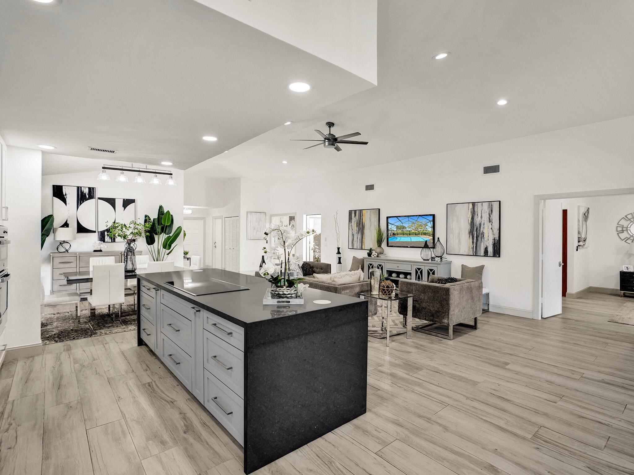 10698 Crystal Lake Drive Boca Raton, FL 33428 - Photo 11 of 48 a kitchen with stainless steel appliances kitchen island granite countertop a large island in the center