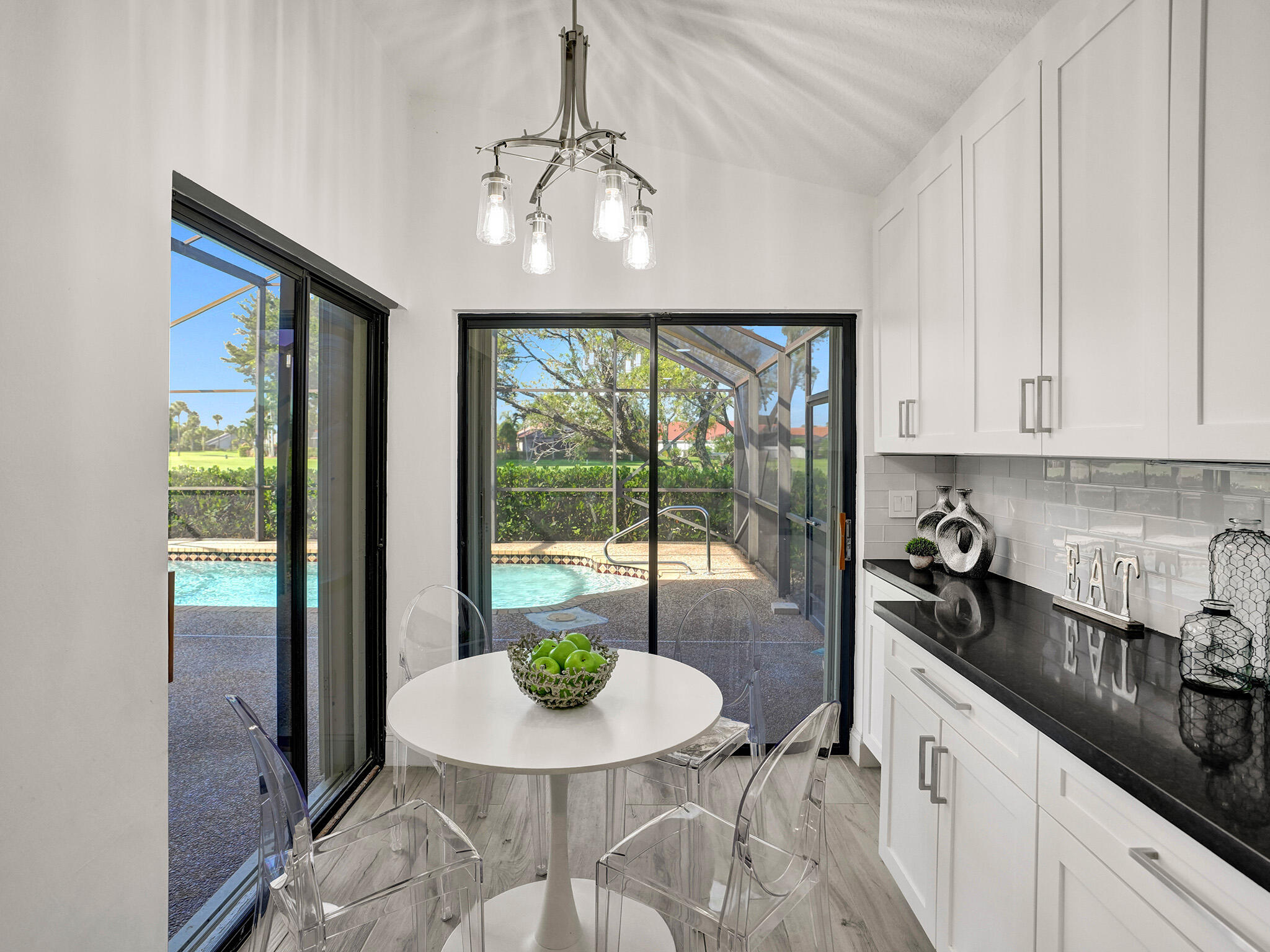10698 Crystal Lake Drive Boca Raton, FL 33428 - Photo 13 of 48 a kitchen with a table and chairs in it