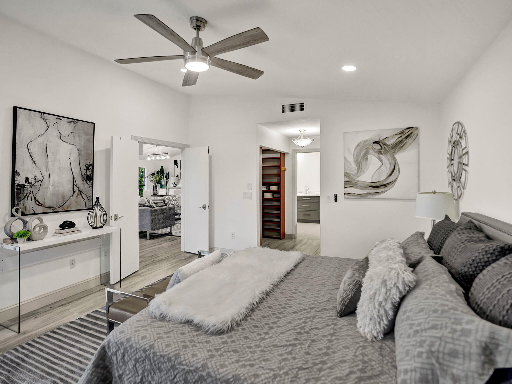 10698 Crystal Lake Drive Boca Raton, FL 33428 - Photo 15 of 48 a bedroom with a bed and a chandelier