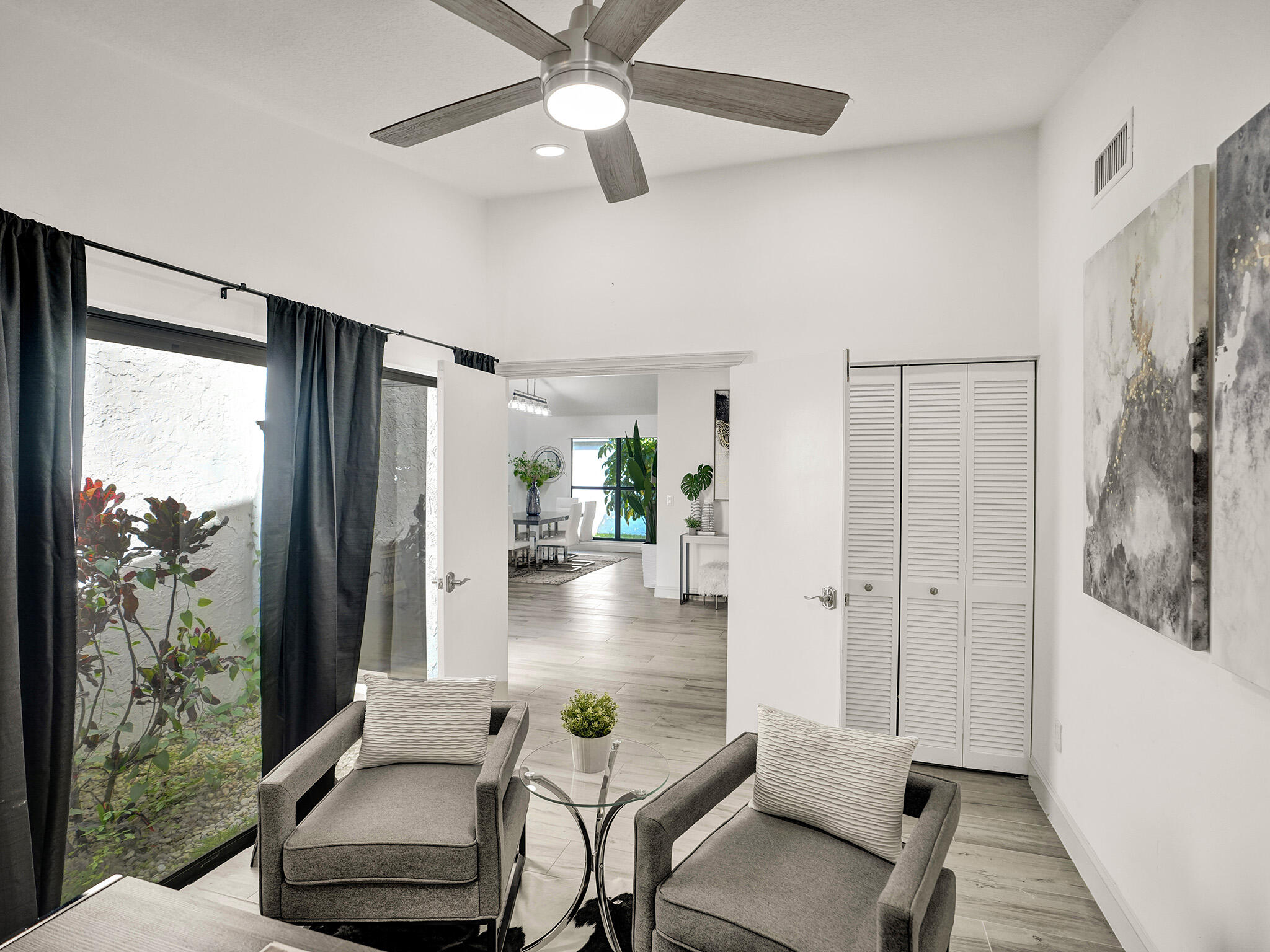 10698 Crystal Lake Drive Boca Raton, FL 33428 - Photo 29 of 48 a living room with furniture and a floor to ceiling window