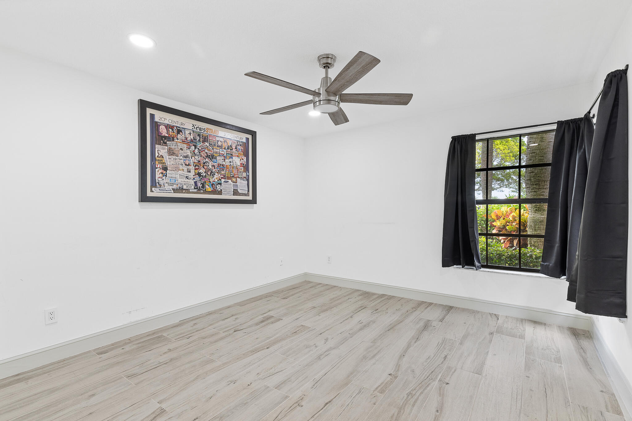 10698 Crystal Lake Drive Boca Raton, FL 33428 - Photo 35 of 48 wooden floor in an empty room with a window