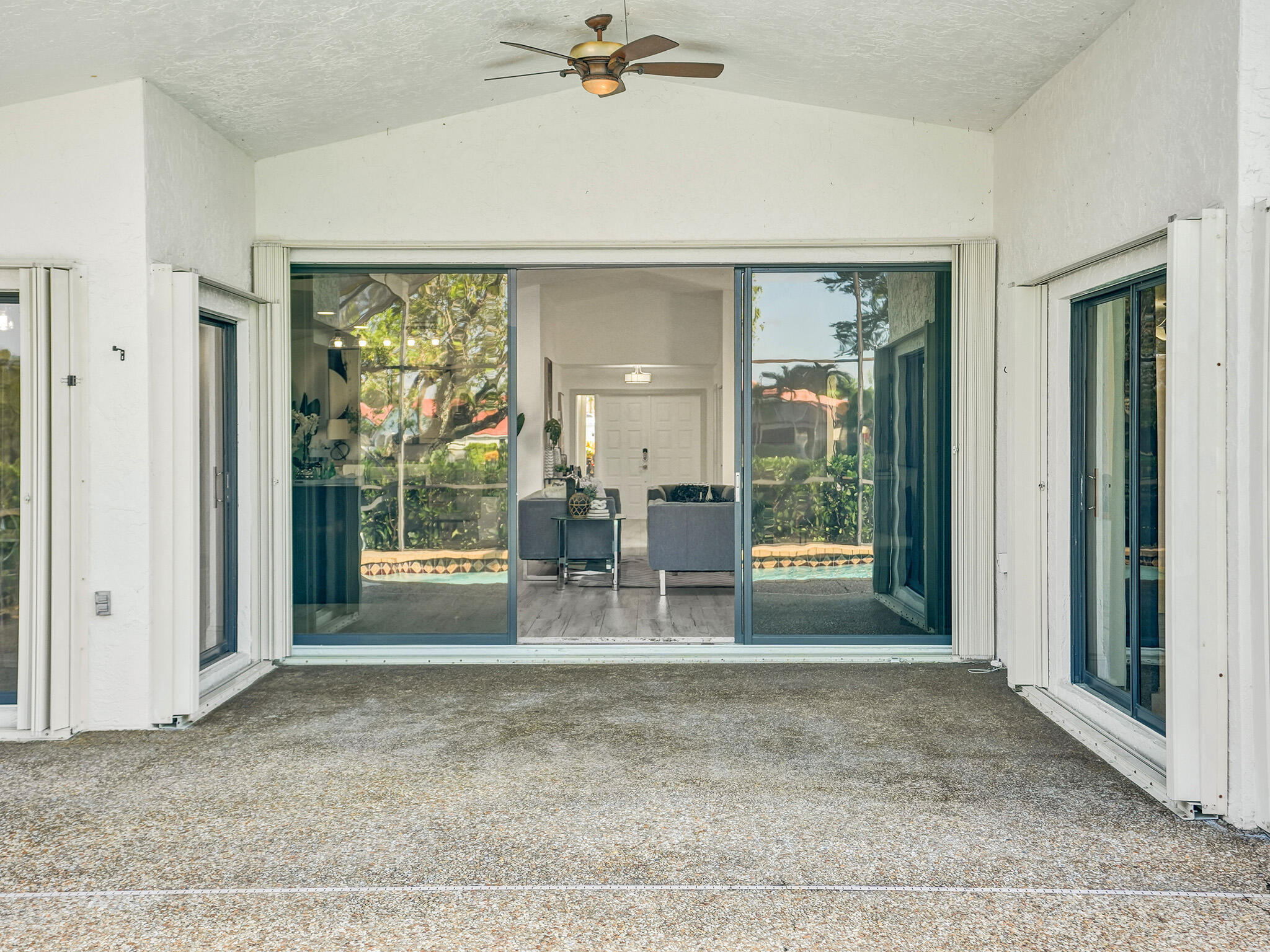 10698 Crystal Lake Drive Boca Raton, FL 33428 - Photo 39 of 48 a view of a livingroom with a furniture wooden floor and a ceiling fan