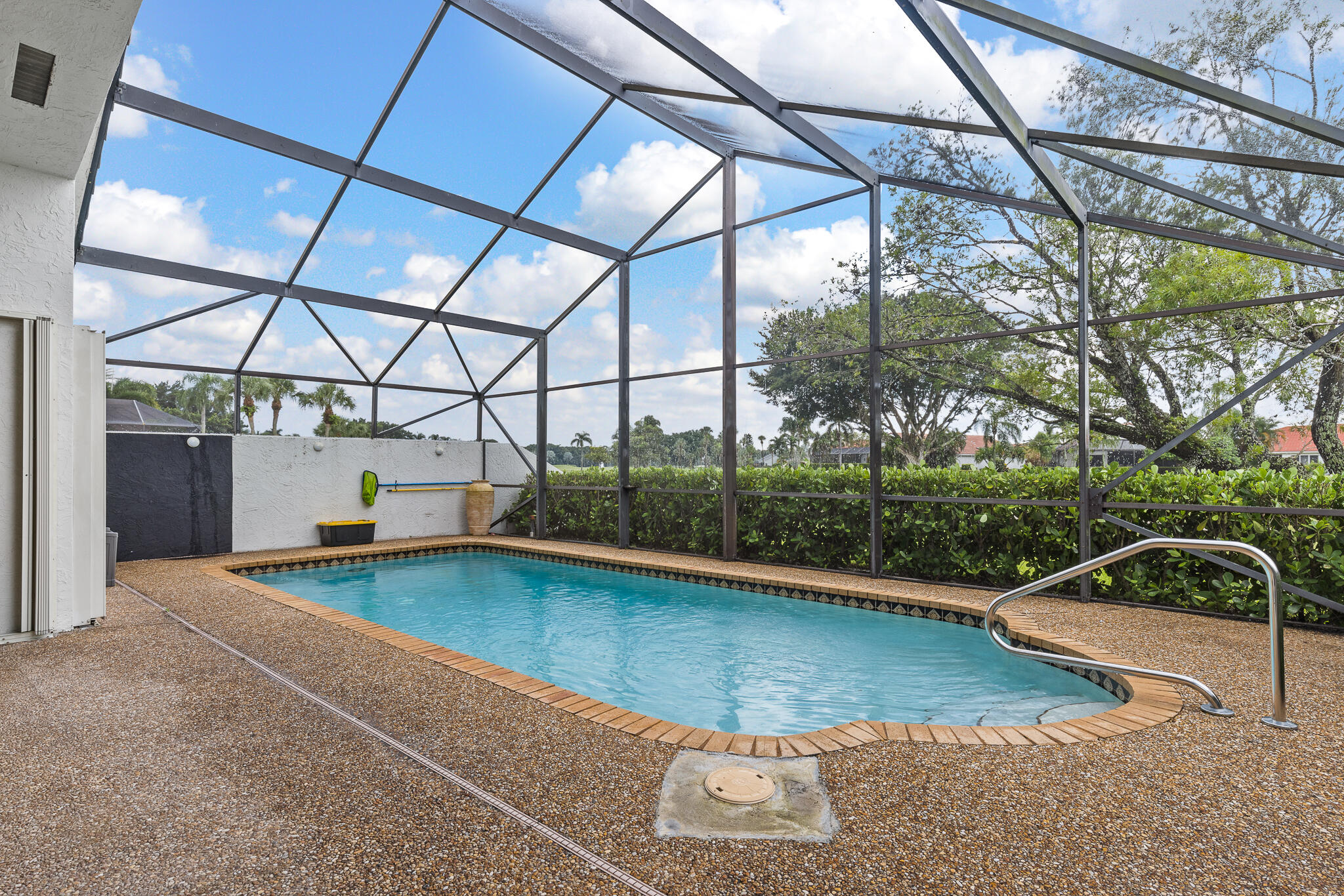 10698 Crystal Lake Drive Boca Raton, FL 33428 - Photo 40 of 48 a view of a swimming pool with a patio and a yard