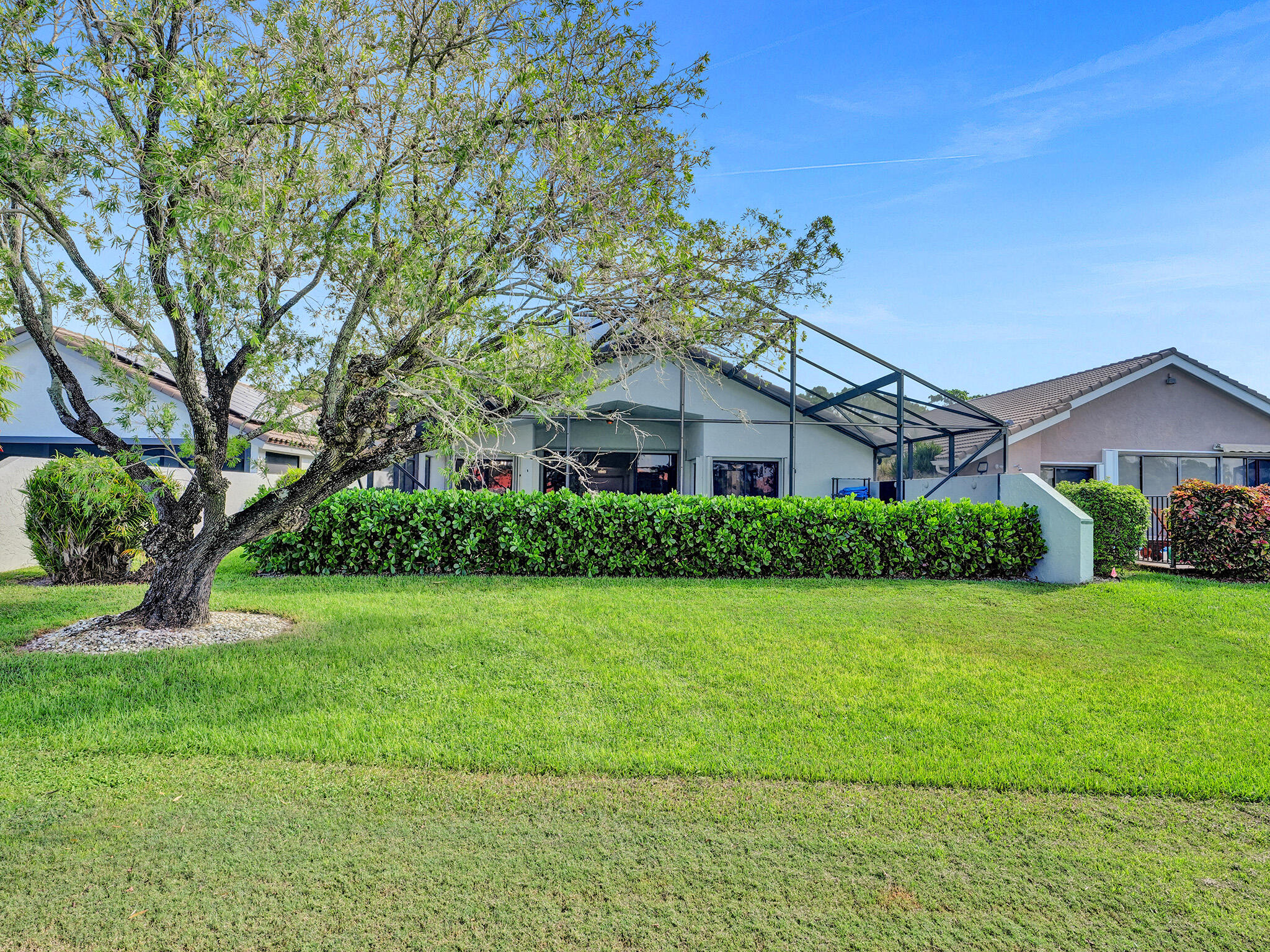 10698 Crystal Lake Drive Boca Raton, FL 33428 - Photo 46 of 48 a front view of a house with garden