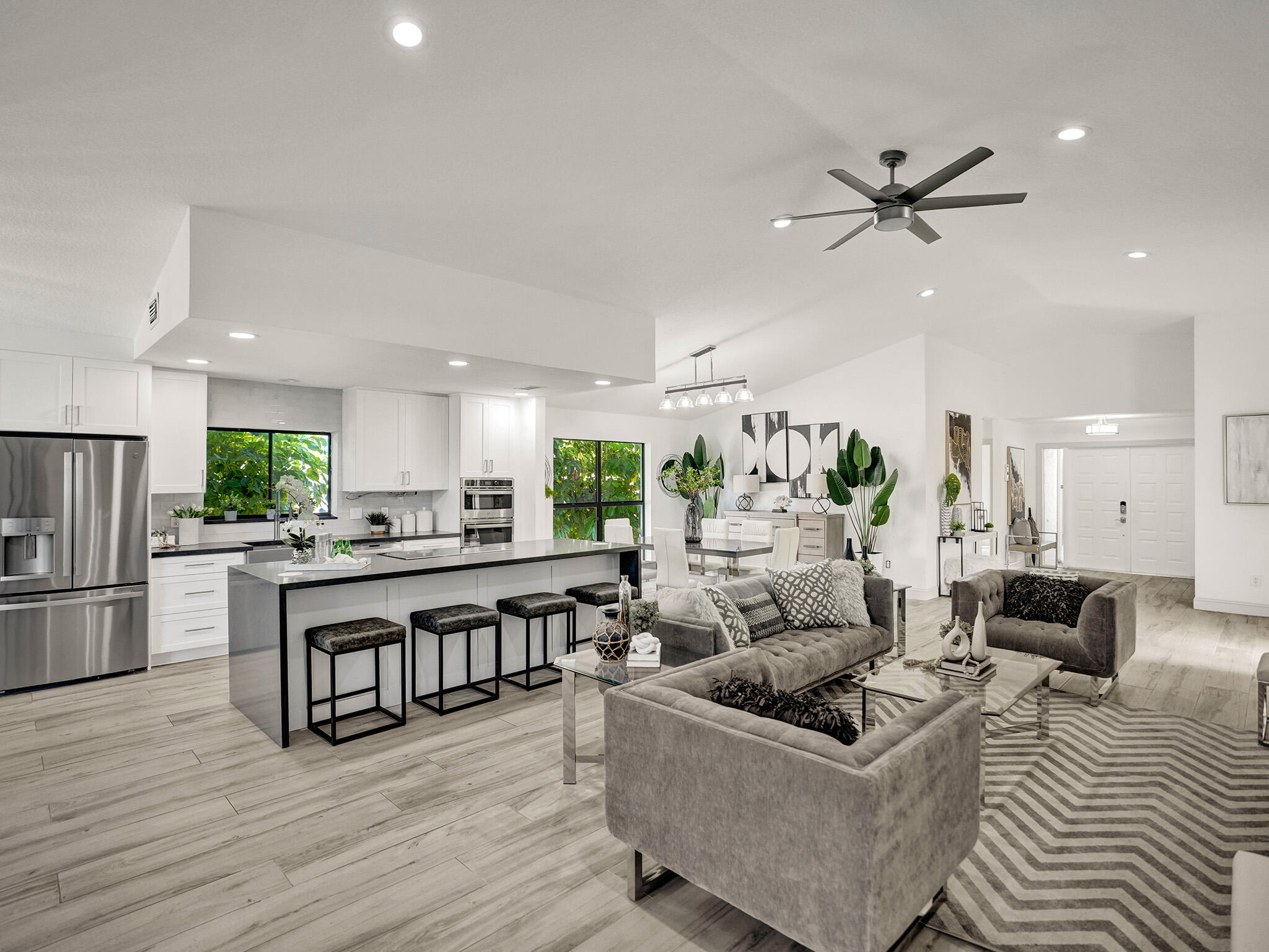 10698 Crystal Lake Drive Boca Raton, FL 33428 - Photo 7 of 48 a living room with stainless steel appliances furniture and a view of kitchen