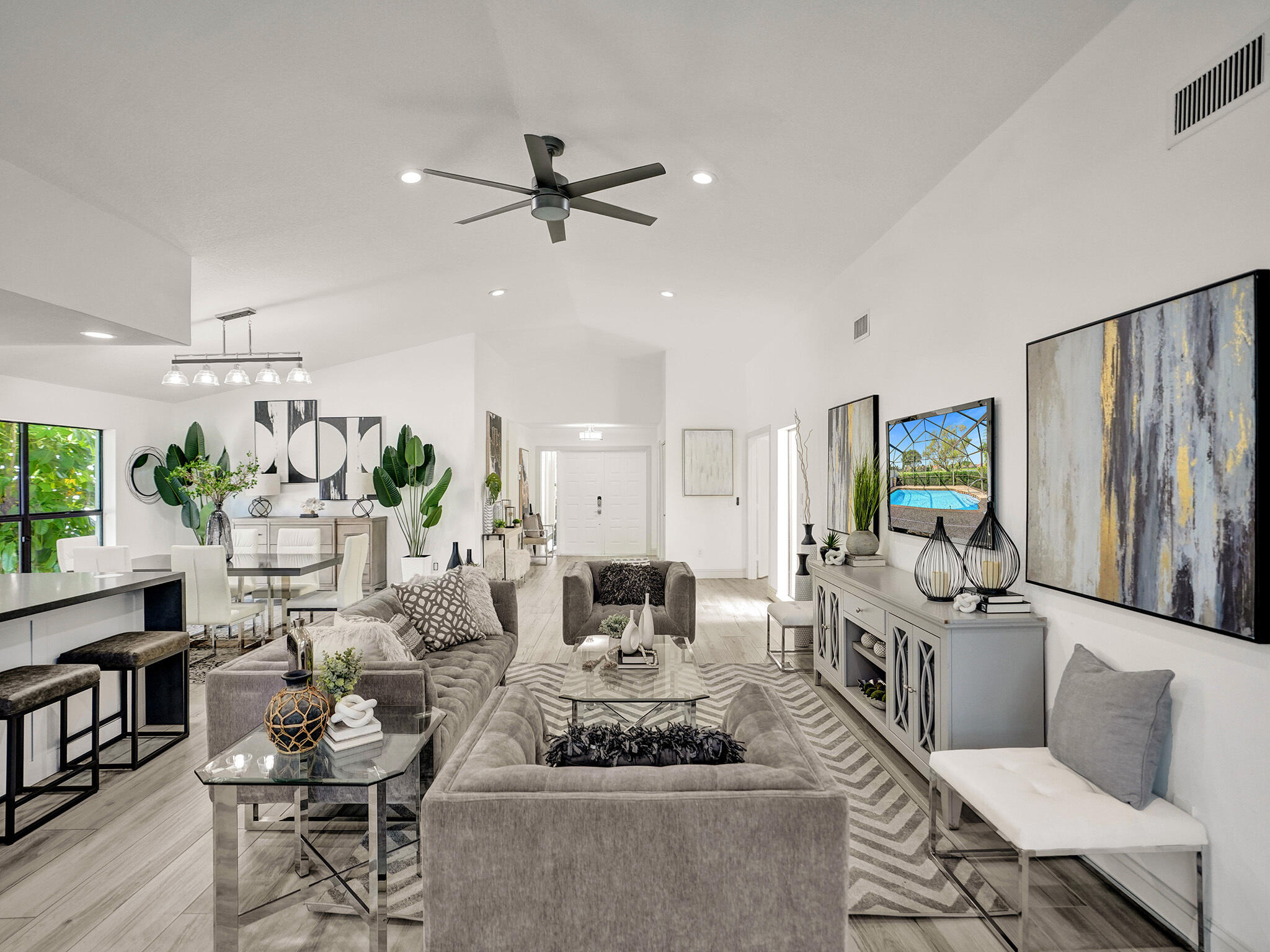 10698 Crystal Lake Drive Boca Raton, FL 33428 - Photo 8 of 48 a living room with furniture and a chandelier