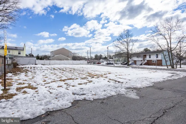 a view of snow on the roadside