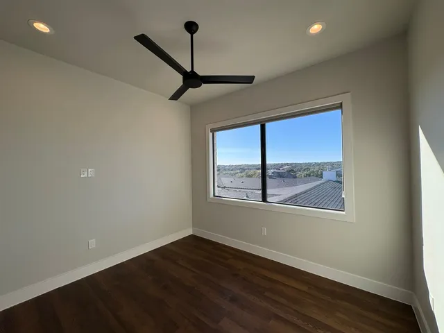 a bathroom with a granite countertop sink a toilet a mirror and bathtub