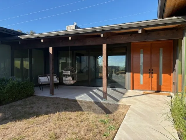a living room with a large window and furniture