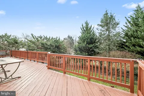 a balcony with wooden floor and fence