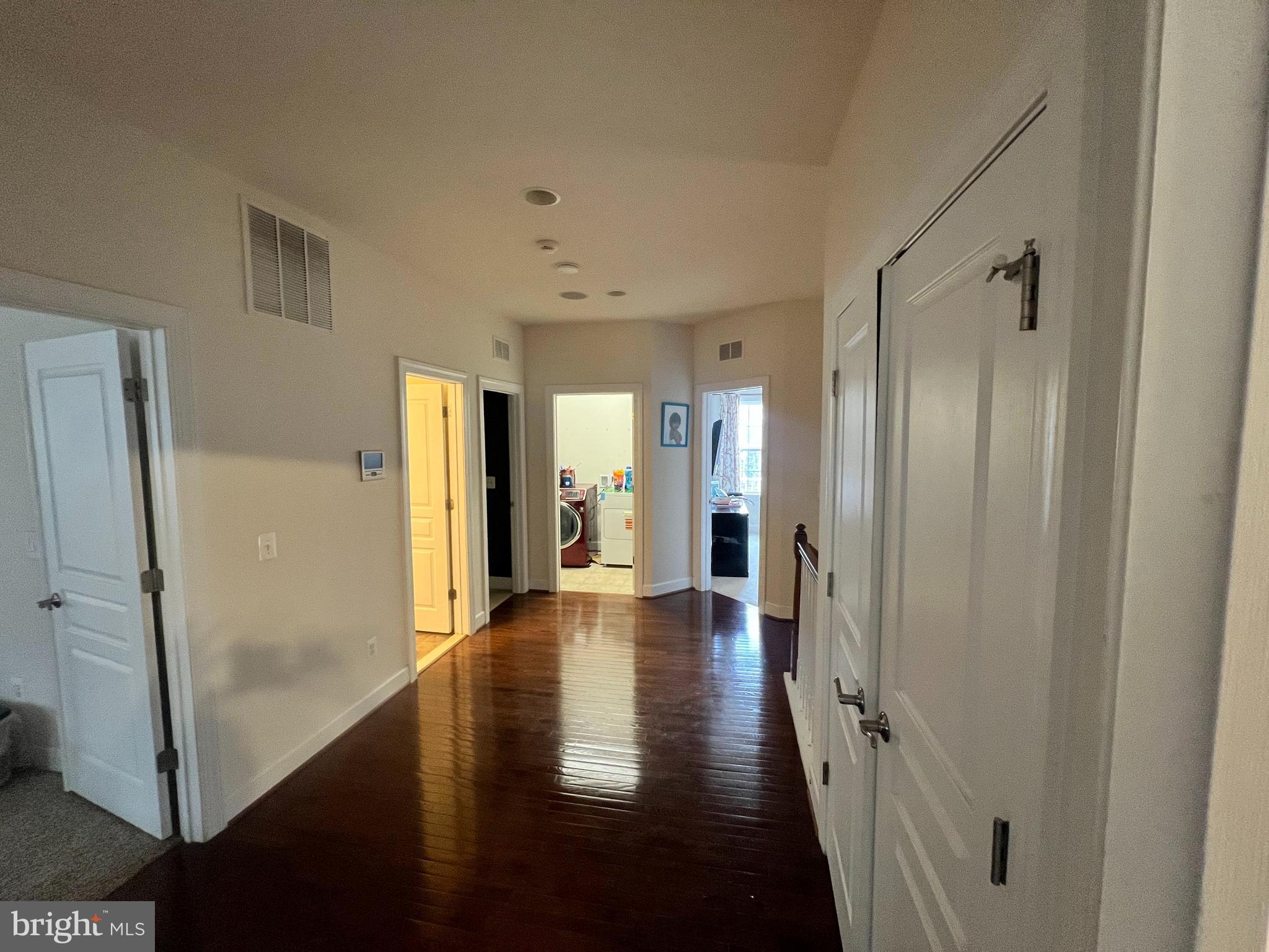 42443 Reservoir Ridge Place Ashburn, VA 20148 - Photo 19 of 22 a view of a hallway with wooden floor and staircase