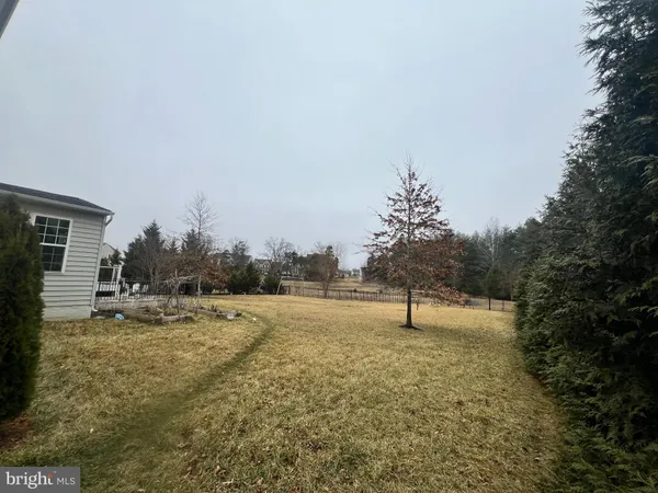 a blue bench sitting in the middle of a yard