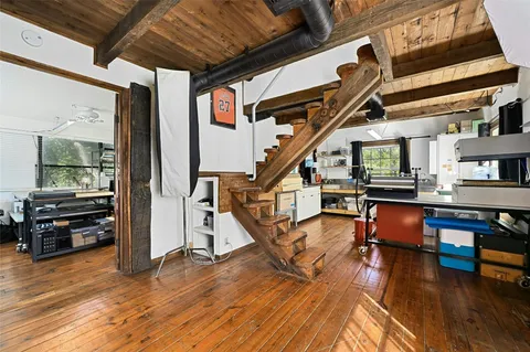 a view of livingroom with furniture wooden floor and a book shelf