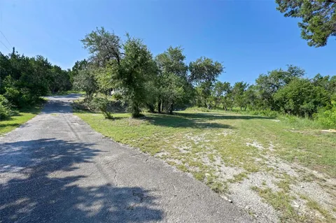 a view of a yard with a tree