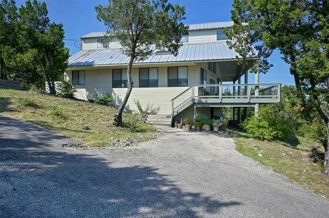 a front view of a house with a yard garage and outdoor seating