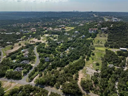 an aerial view of house with yard and mountain view in back