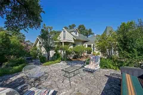a view of a backyard with plants and a garden