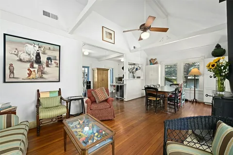 a living room with furniture and wooden floor