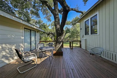 a view of balcony with chairs and wooden fence