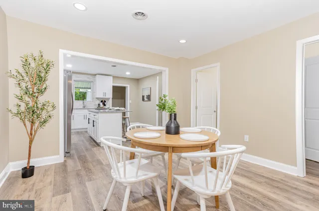a dining room with furniture and wooden floor