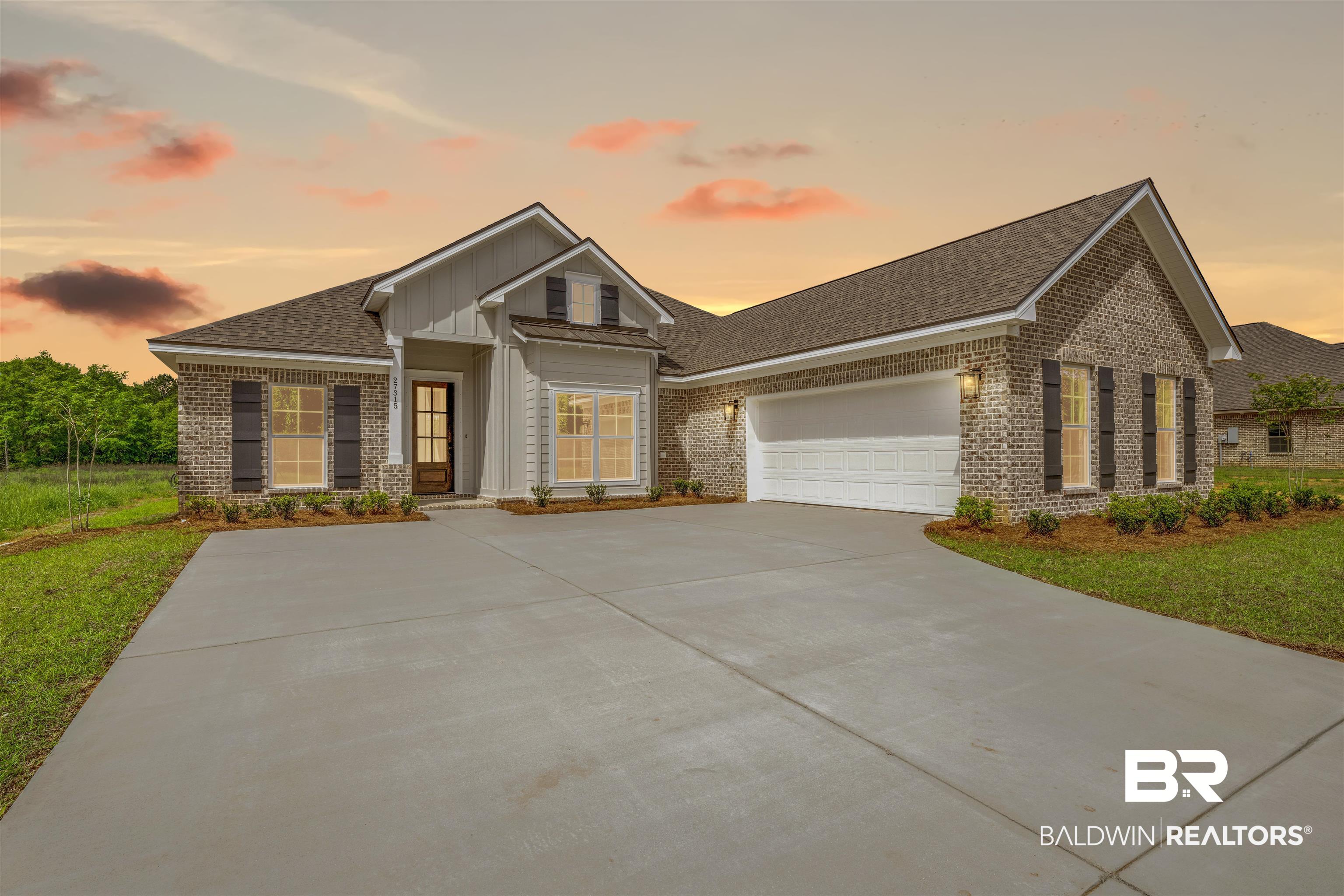 27315 Patch Pl Loop Daphne, AL 36526 - Photo 35 of 43 View of front of property featuring brick siding, a garage, roof with shingles, driveway, and board and batten siding