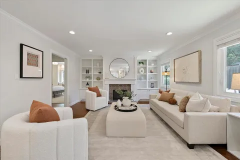 a living room with furniture a large window and a clock