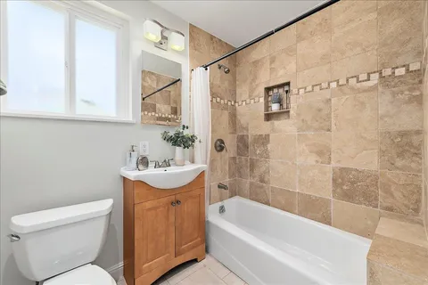 a bathroom with a sink a toilet and bathtub