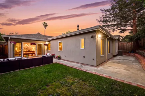a front view of house with yard and outdoor seating