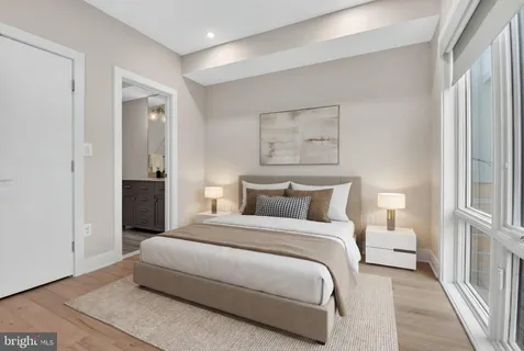 a bedroom with a bed and a painting on the wall