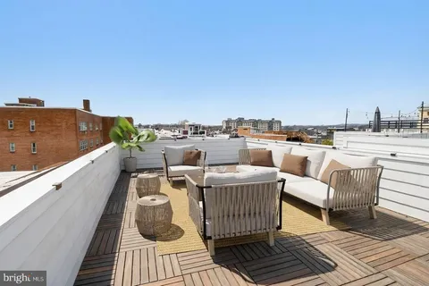 a view of roof deck with seating space and a barbeque